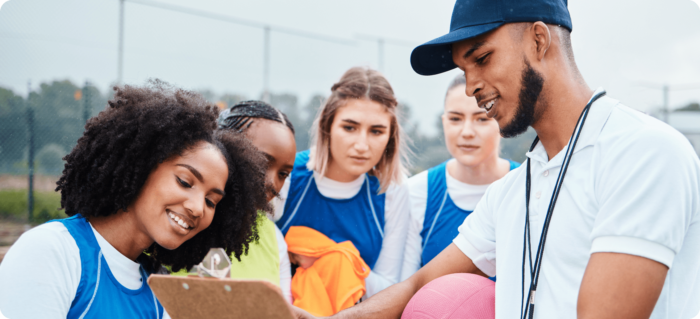 A recreational sport team speaking with a coach